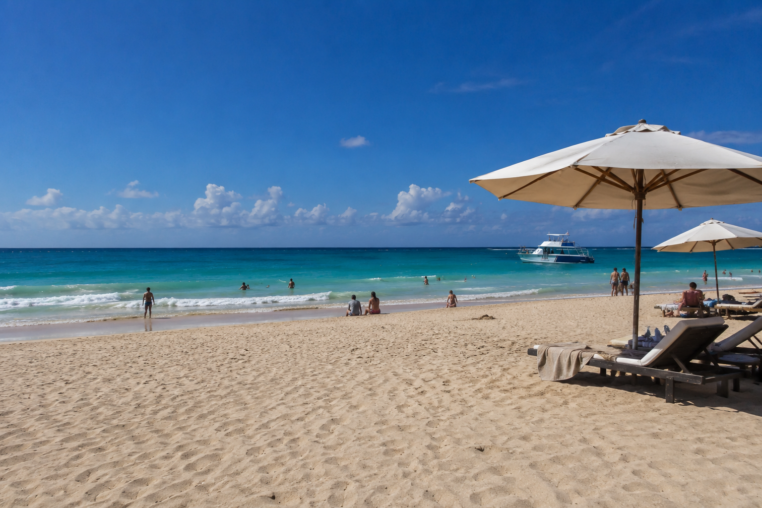 Sun loungers and thatched umbrellas on white sand beside turquoise Caribbean water in Punta Cana